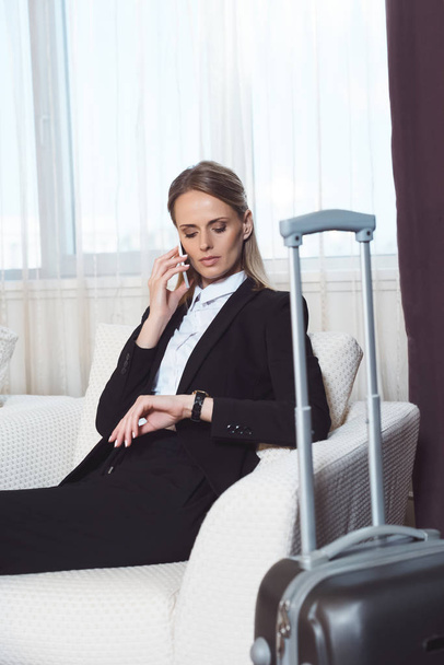 businesswoman with smartphone in hotel room - Photo, Image