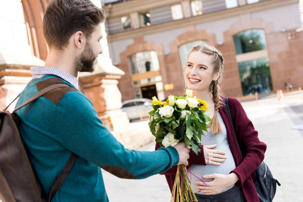 man presenting flowers to wife - Φωτογραφία, εικόνα