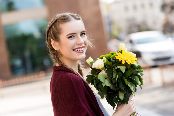 happy woman with bouquet of flowers - Фото, изображение