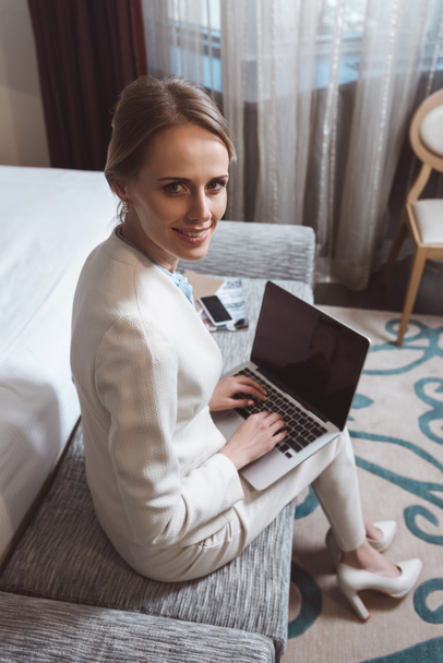 businesswoman using laptop in hotel room - Photo, Image