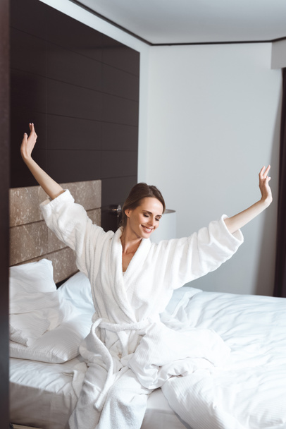 woman waking up in hotel room - Фото, изображение