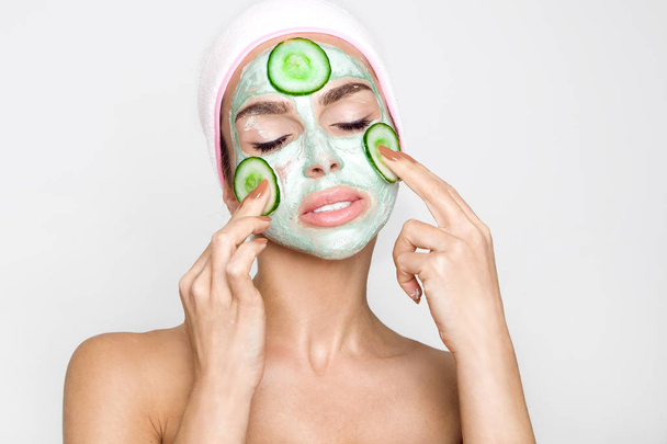 Beautiful blonde woman with a facial mask, beauty spa - 写真・画像