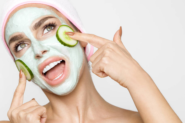 Beautiful blonde woman with a facial mask, beauty spa - Photo, Image