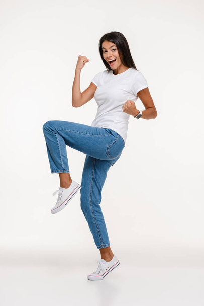 Full length portrait of happy casual woman celebrating success - Foto, afbeelding