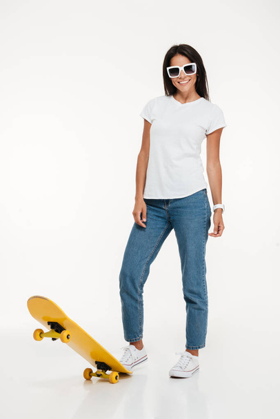 Full length portrait of a young woman in sunglasses posing - Foto, Imagem