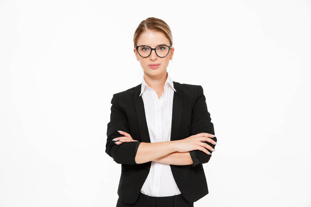 Cool blonde business woman in eyeglasses posing in studio - Фото, зображення