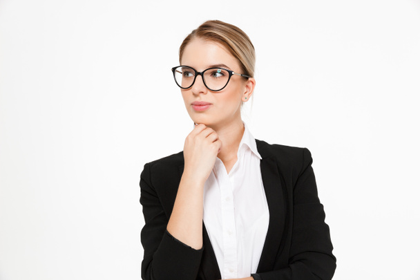 Attractive blonde business woman in eyeglasses holding hand near chin - Foto, afbeelding