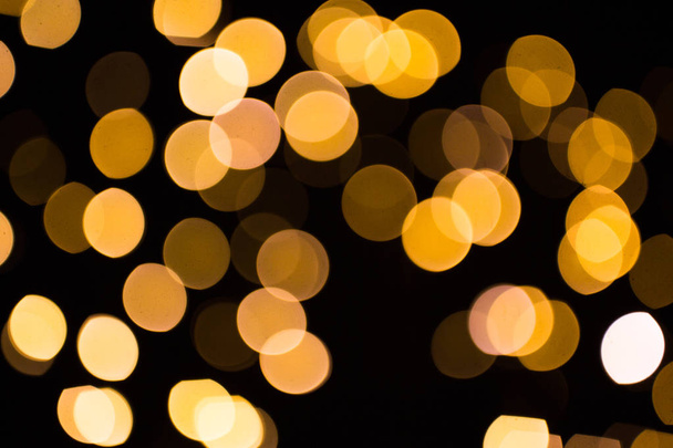 blurred golden lights over dark background - Photo, image