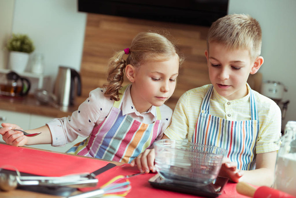 Portrait of two happy children having fun during cooking christm - Фото, изображение