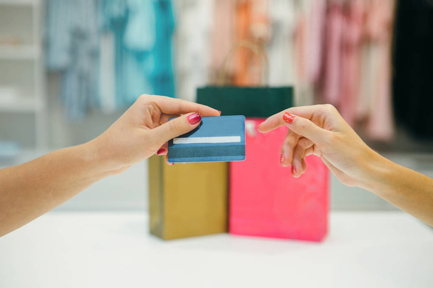 Woman in shop with credit card  - Фото, изображение