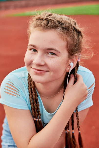 A young bright girl loves sports. Closeup portrait of a teenage girl. - Foto, Imagen