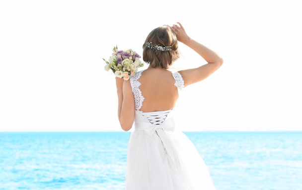 Happy young bride on sea beach - Фото, зображення
