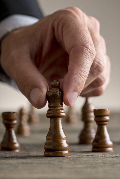 Man playing chess moving black queen piece - Фото, зображення
