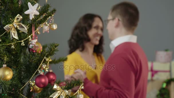 Happy loving couple dancing at Christmas party, saying wishes to each other - Imágenes, Vídeo