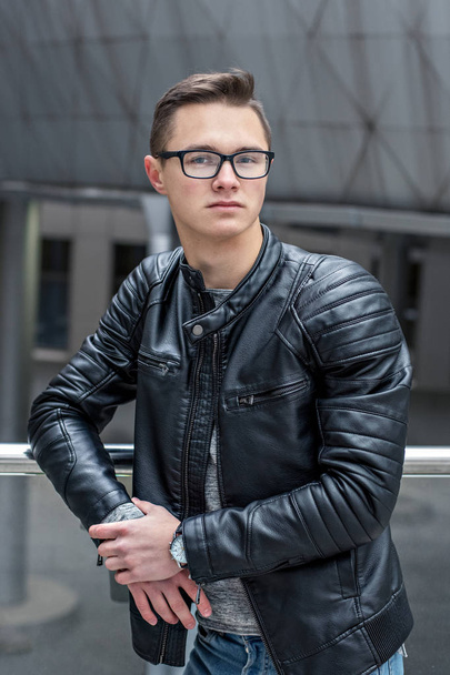 smart guy in eyeglasses and black leather jacket in front of the library - Фото, зображення
