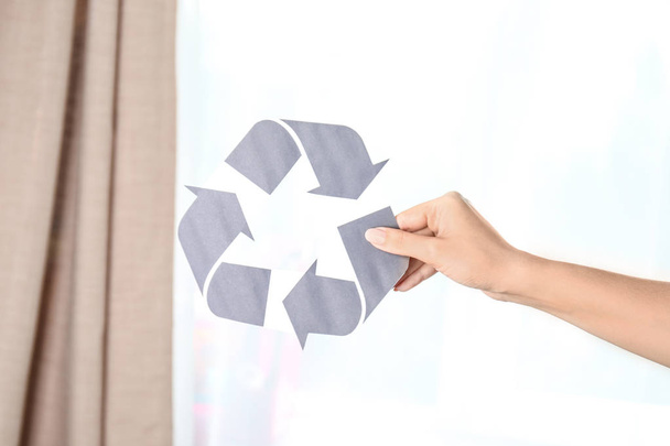 Woman holding symbol of recycling indoors - 写真・画像