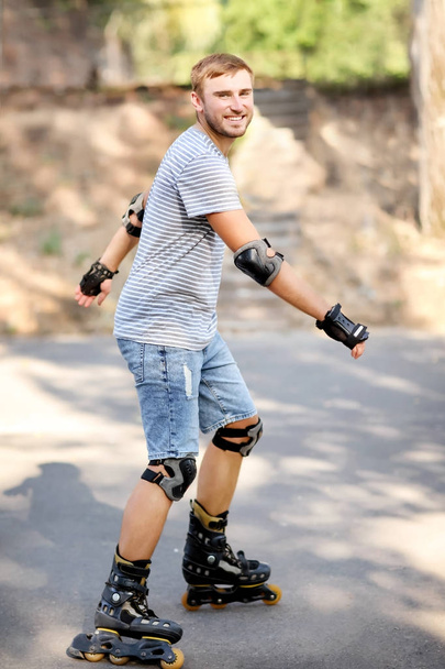 Young man rollerskating in park - Photo, Image