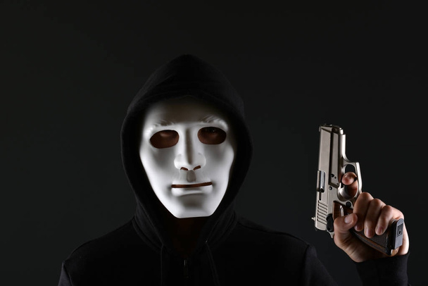 Maskierter Krimineller mit Waffe - Foto, Bild