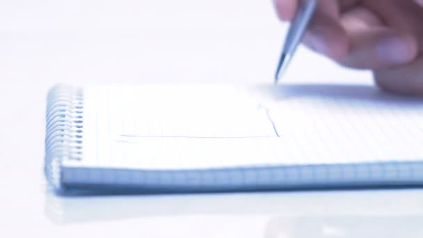 Male hand is writing in business document lying on the table. Close-up. - Video