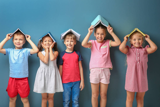 Cute little children with books on color background - Fotografie, Obrázek