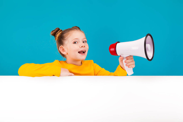 Blonde little girl holds a megaphone - Photo, Image