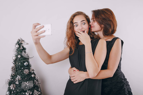 Mom and daughter decorating Christmas tree - Foto, imagen
