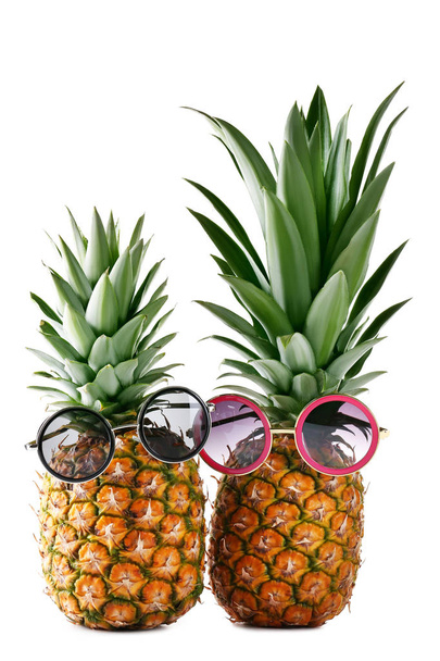 Ripe pineapples with sunglasses  - Фото, зображення