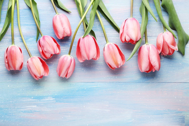 Pink tulips on wooden table - Фото, зображення