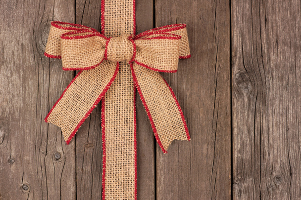 Burlap Christmas bow and ribbon side border on wood - Photo, Image