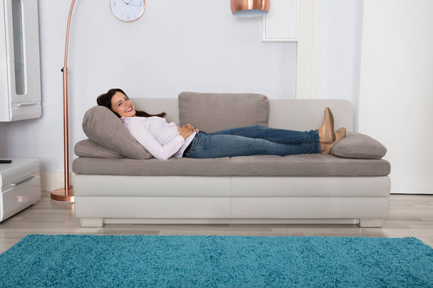 Woman Relaxing On Couch - Φωτογραφία, εικόνα