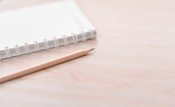 Blur pencil and notebook in white tone. - Фото, зображення