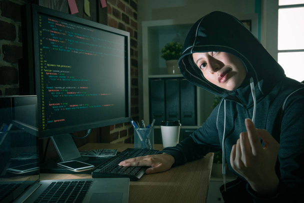 beautiful young female hacker face to camera - Photo, Image