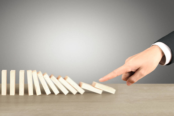 Hand Stopping domino concept , business solution - Photo, Image