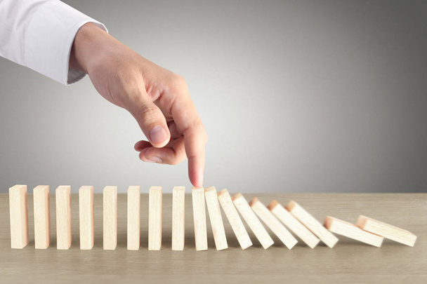 Hand Stopping domino concept , business solution - Photo, Image