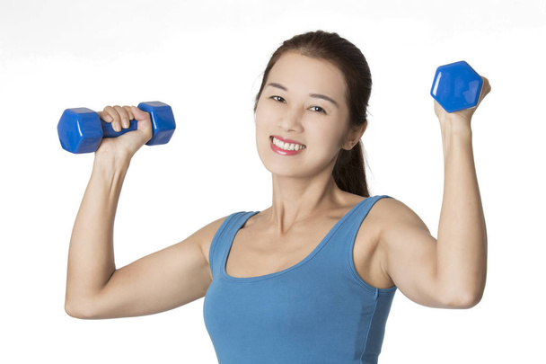Asian woman working out using dumbbell weights isolated on white - Fotó, kép