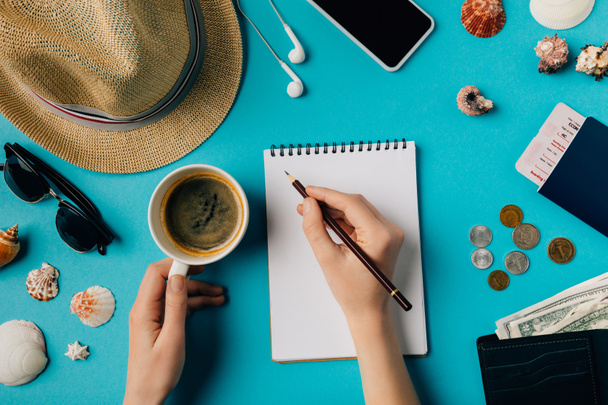 Woman planning travel with notebook and pencil - Φωτογραφία, εικόνα