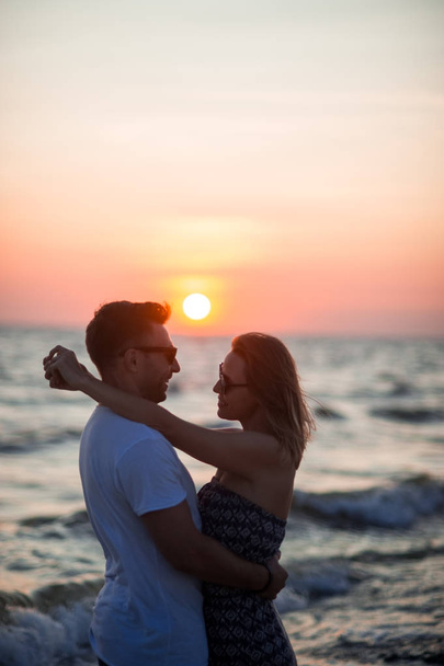 Couple of lovers stands having embraced on the seashore. - Valokuva, kuva
