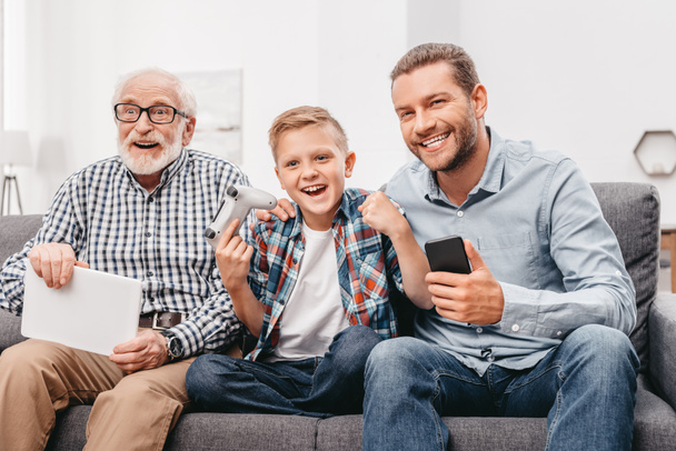 Family cheering for boy playing videogames - Foto, Bild
