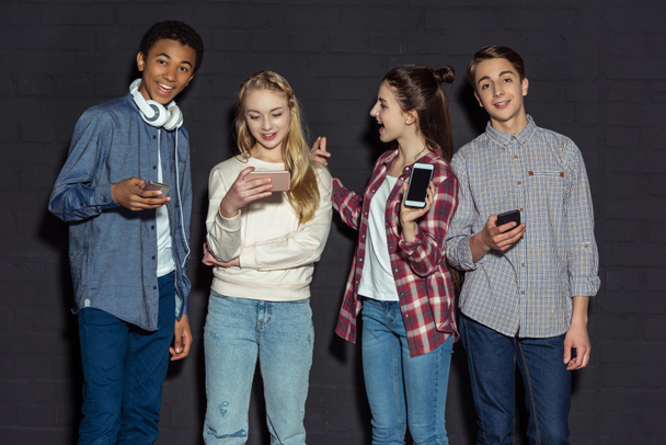 stylish teenagers with smartphones - 写真・画像
