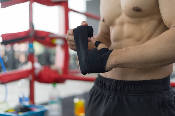 Fitness man in training put fitness Gloves in gym, fitness concept, sport concept - Fotoğraf, Görsel
