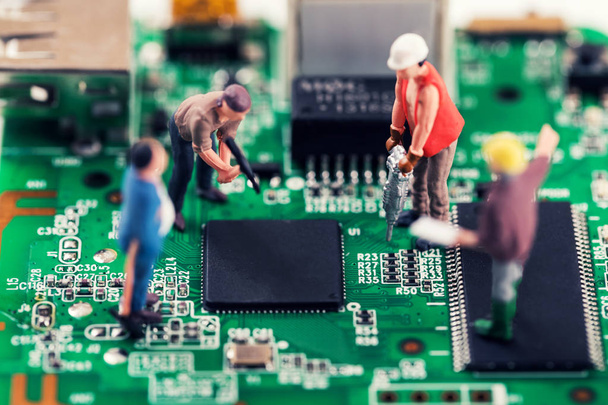 electronics repair and tech support concept - workers repairing circuit board - Photo, Image