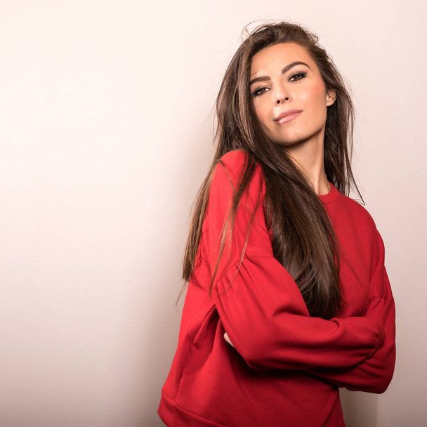 Young sensual model woman in red pose in studio. - Фото, зображення