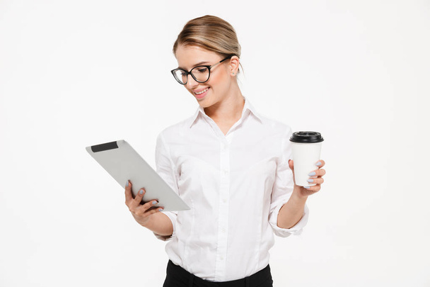 Smiling blonde business woman in eyeglasses using tablet computer - Фото, изображение