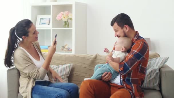 happy family with baby photographing at home - Footage, Video