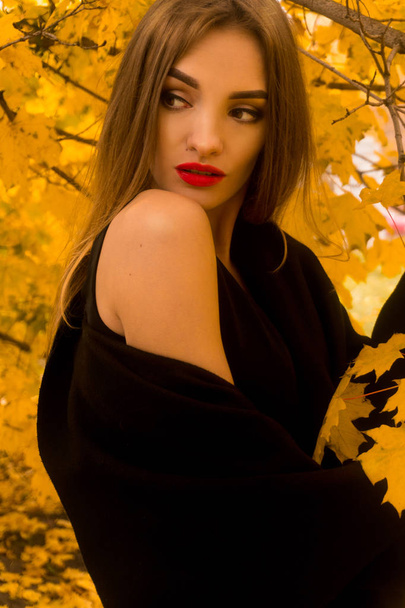portrait of beautiful young girl in black coat - Fotó, kép