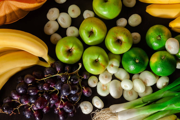 Fresh vegetables and fruits  over a dark background. the concept - Foto, immagini