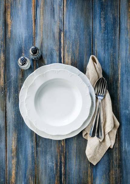 empty plate on a wooden background of old shabby boards. backgro - Photo, Image