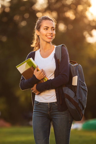 Portrait of a happy young schoolgirl with backpack - Foto, Imagem