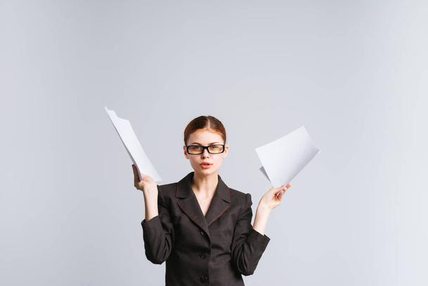 young modern successful girl in glasses and a strict suit holds important documents in her hands - Foto, Imagen