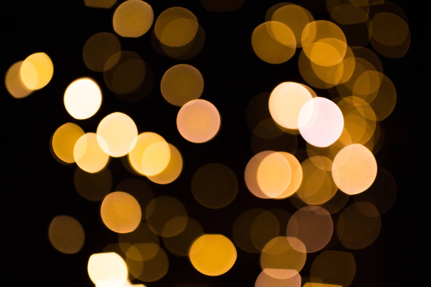 blurred golden lights over dark background - Photo, image